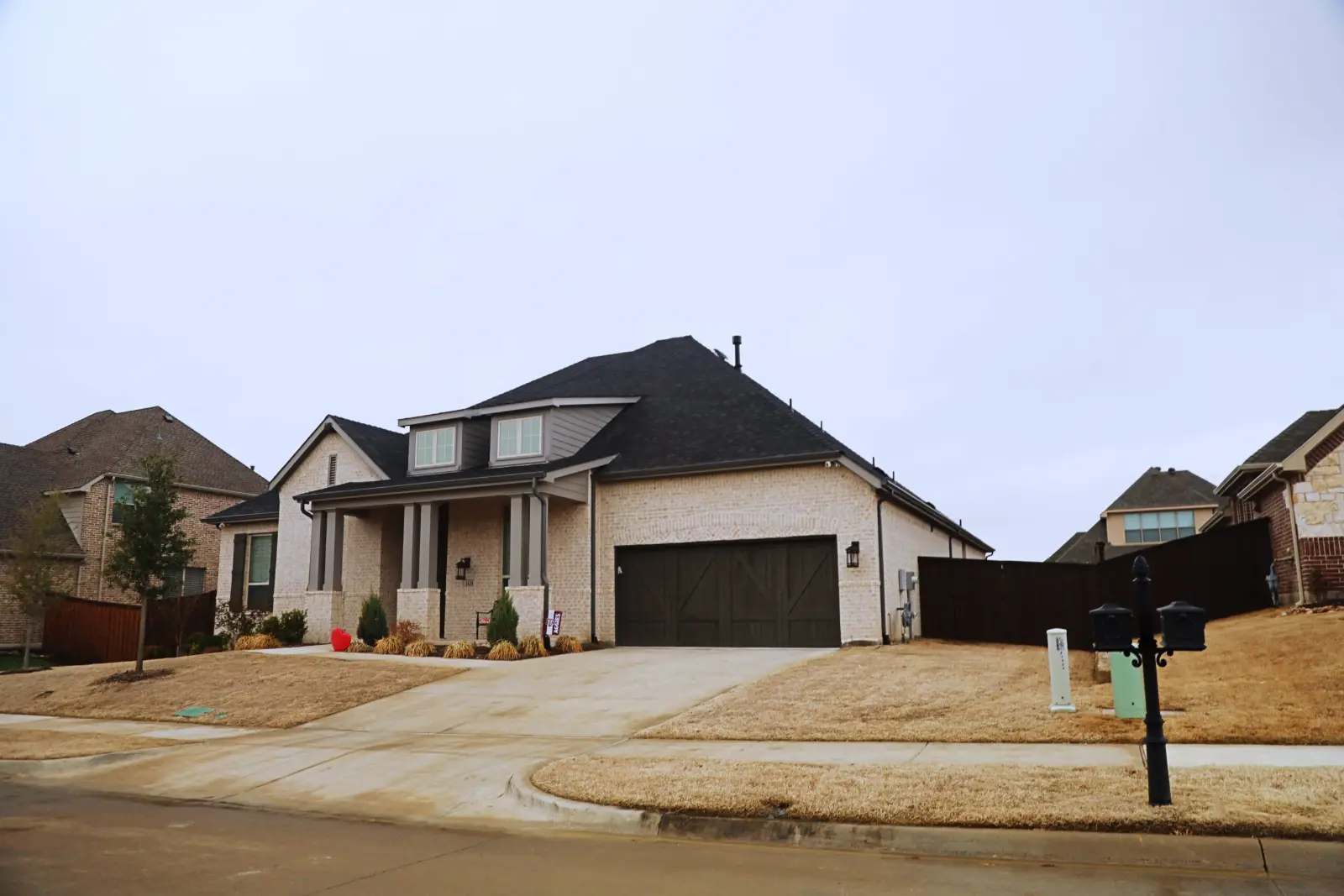 Completed shingle roof on a brick and stone home in North Texas
